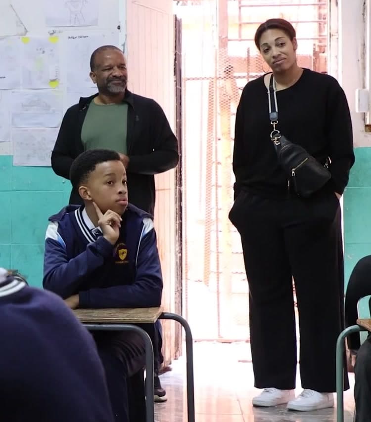 Chris Folayan of Luma Learn in a classroom, listening to learners' questions